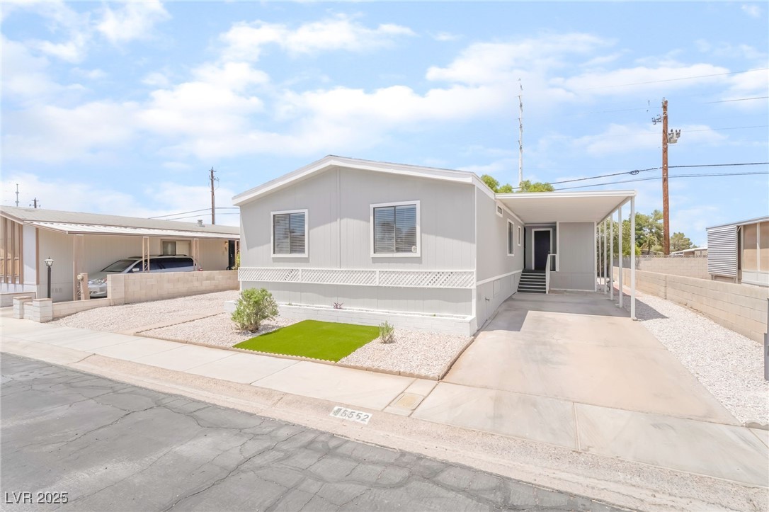 5552 Aldama Road Las Vegas, NV 89122 - Photo 1 of 35 Manufactured / mobile home featuring concrete driveway and an attached carport