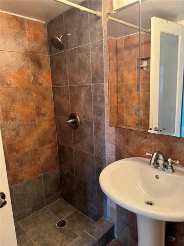 a bathroom with a sink and shower