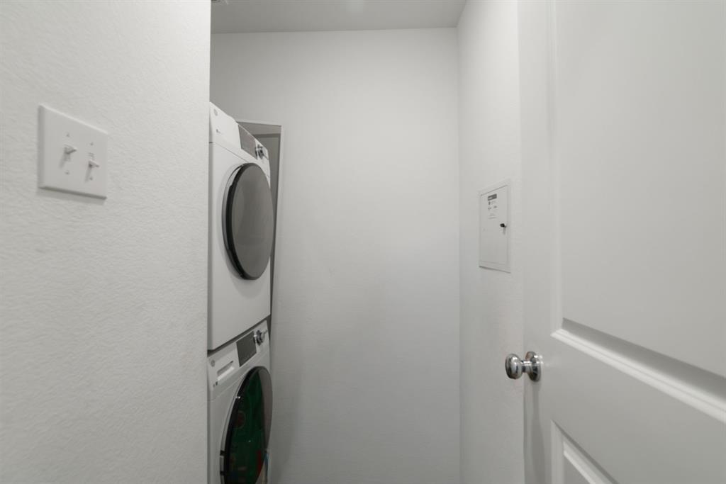 1445 Sterling Way Ferris, TX 75125 - Photo 6 of 17 Laundry area featuring stacked washing machine and dryer