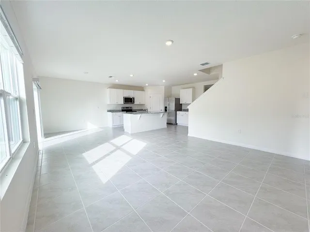 a kitchen with stainless steel appliances a sink a stove a microwave a sink a refrigerator and cabinets