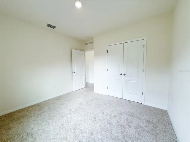 a view of an empty room and closet area