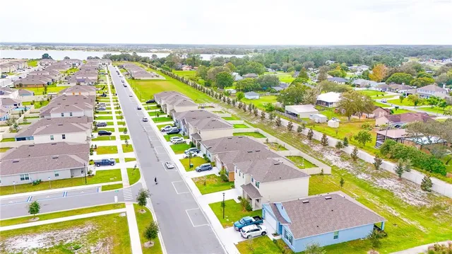 an aerial view of residential houses with outdoor space