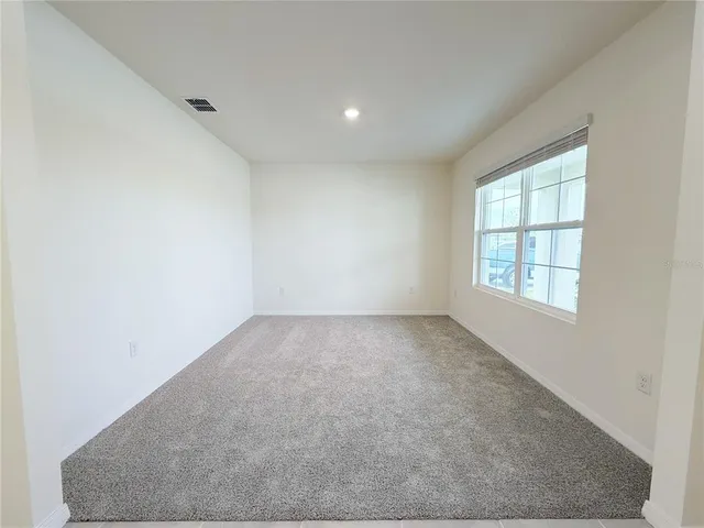 a large kitchen with kitchen island granite countertop a sink refrigerator and cabinets