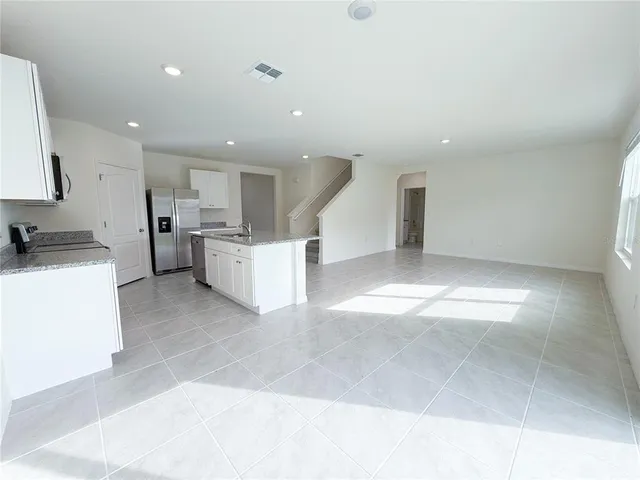 a view of a kitchen with a sink and a window