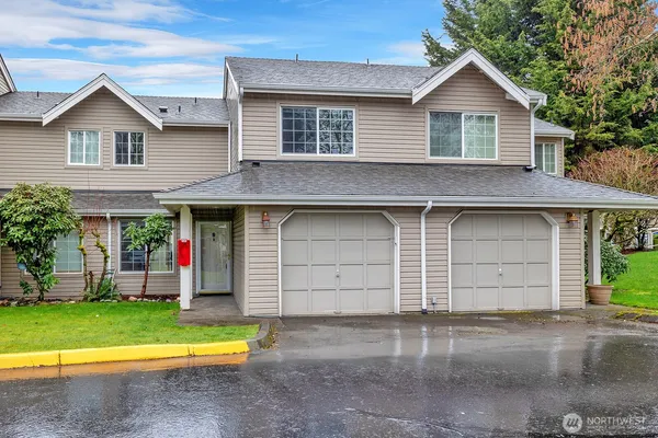 a front view of a house with a yard and garage