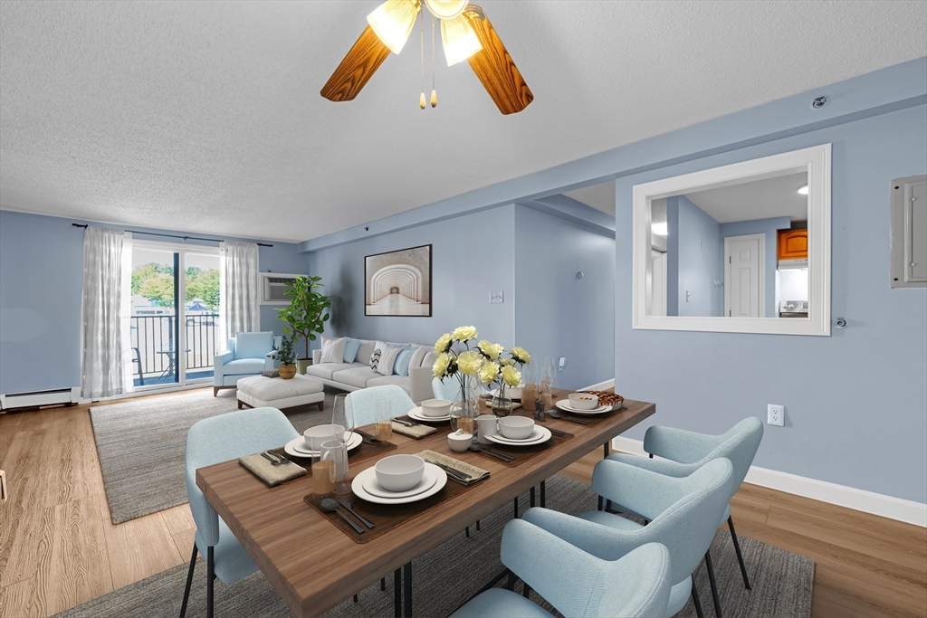 688 Boston Post Road East, Unit 228 Marlborough, MA 01752 - Photo 3 of 22 a dining room with furniture and a floor to ceiling window