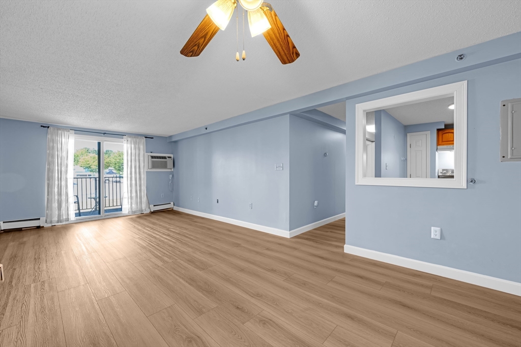 688 Boston Post Road East, Unit 228 Marlborough, MA 01752 - Photo 4 of 22 wooden floor in an empty room with a window