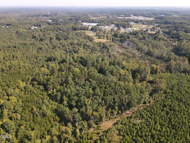an aerial view of residential houses with city view