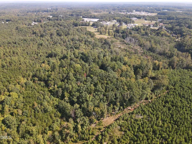 an aerial view of residential houses with city view