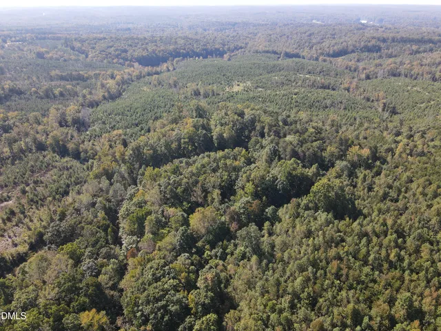 an aerial view of house with yard and mountain view in back