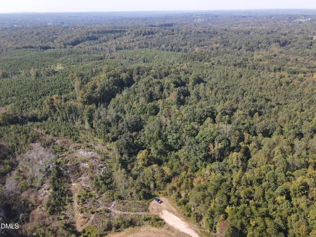 a view of a field with trees and houses