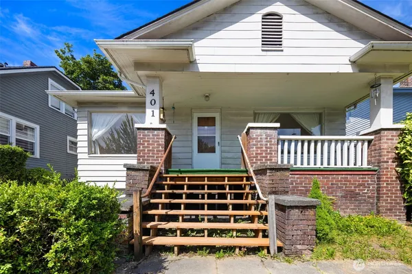 a view of front door of house with stairs