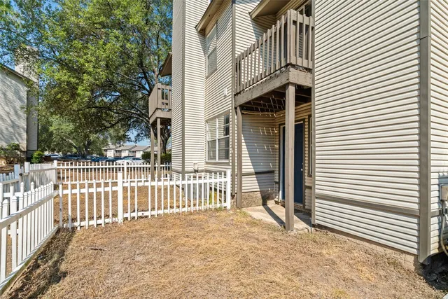 a view of a wooden fence next to a yard
