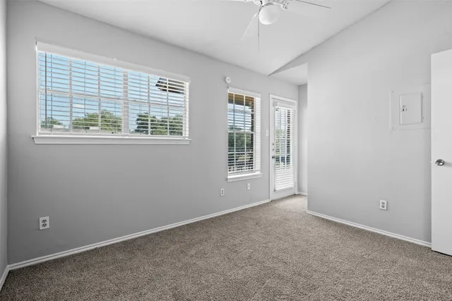 an empty room with windows and closet