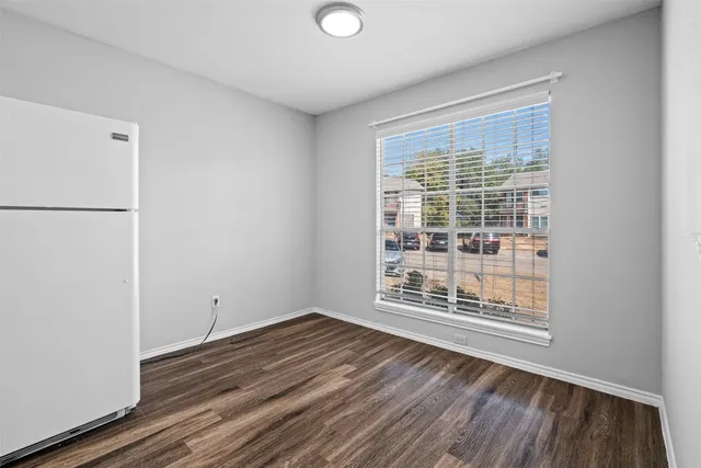 a view of wooden floor and windows in a room