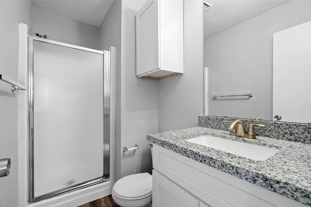 a view of swimming pool with outdoor seating and trees in the background