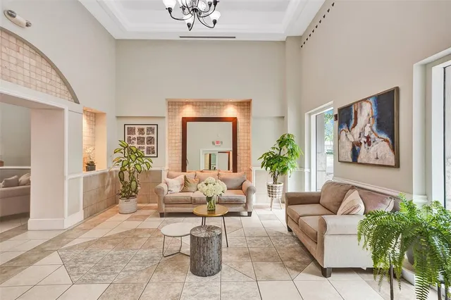 a living room with furniture and a chandelier