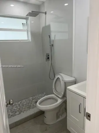 a bathroom with a toilet and a shower