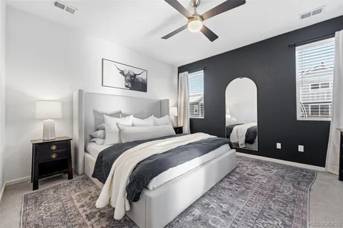 a bedroom with a bed and a lamp