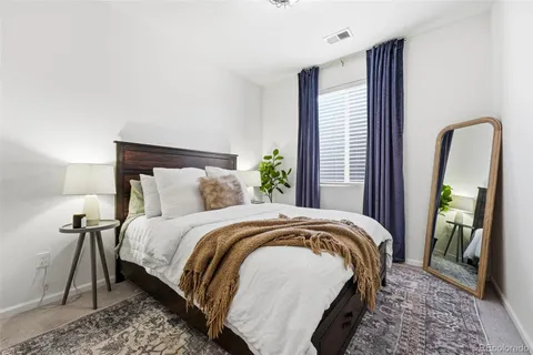 a bed sitting in a bedroom next to a window