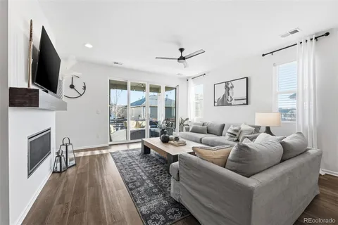 a living room with fireplace furniture and a flat screen tv