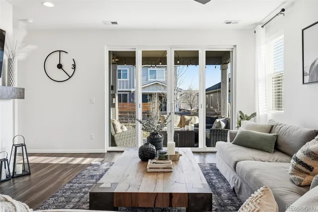a living room with furniture a rug and a window