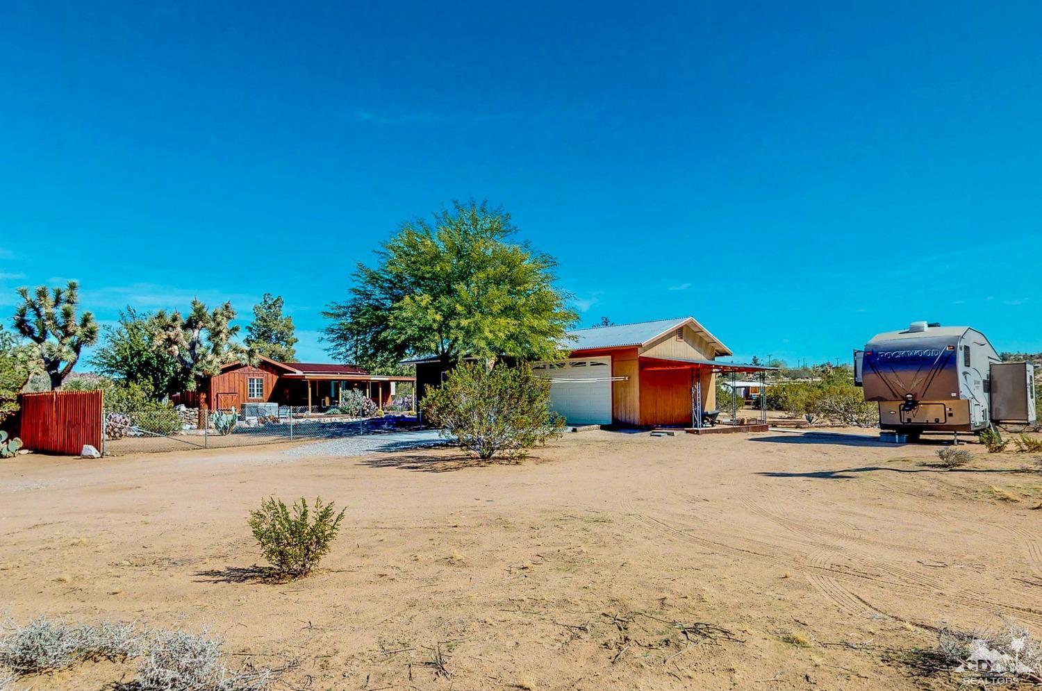 63443 Quail Springs Road Joshua Tree, CA 92252 - Photo 2 of 17 a view of house with outdoor space and sitting area