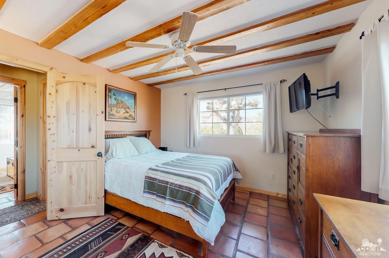 63443 Quail Springs Road Joshua Tree, CA 92252 - Photo 11 of 17 a bedroom with a bed and a window