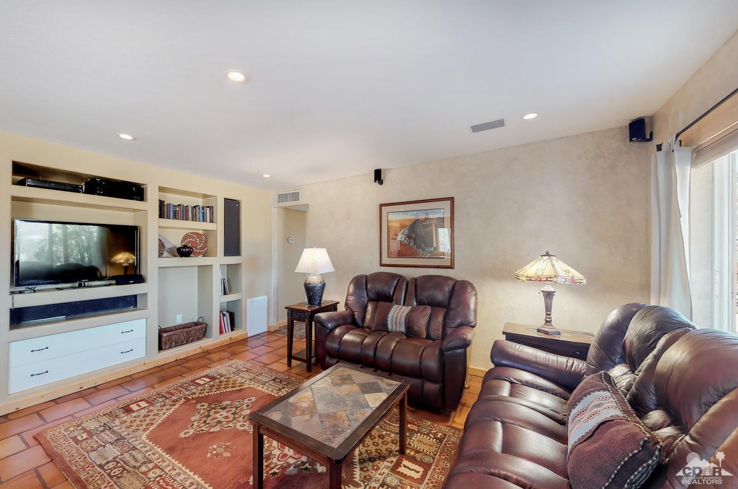 63443 Quail Springs Road Joshua Tree, CA 92252 - Photo 5 of 17 a living room with furniture and a flat screen tv
