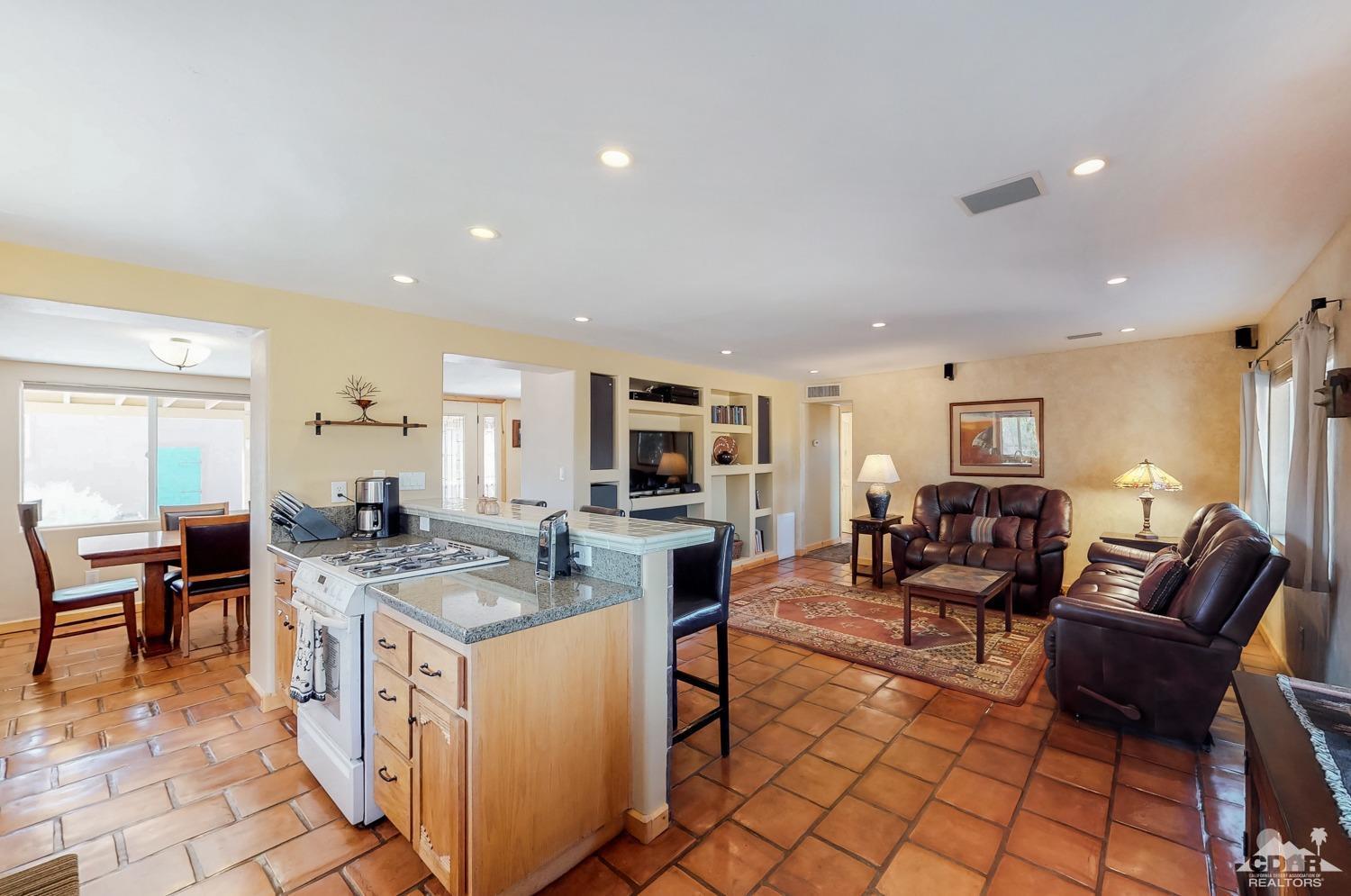 63443 Quail Springs Road Joshua Tree, CA 92252 - Photo 6 of 17 a open kitchen with stainless steel appliances granite countertop a stove and a sink