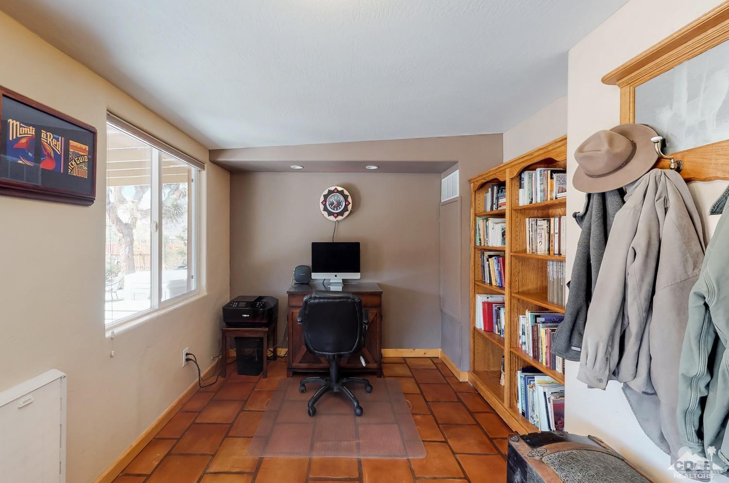 63443 Quail Springs Road Joshua Tree, CA 92252 - Photo 9 of 17 a view of a workspace with furniture and a window