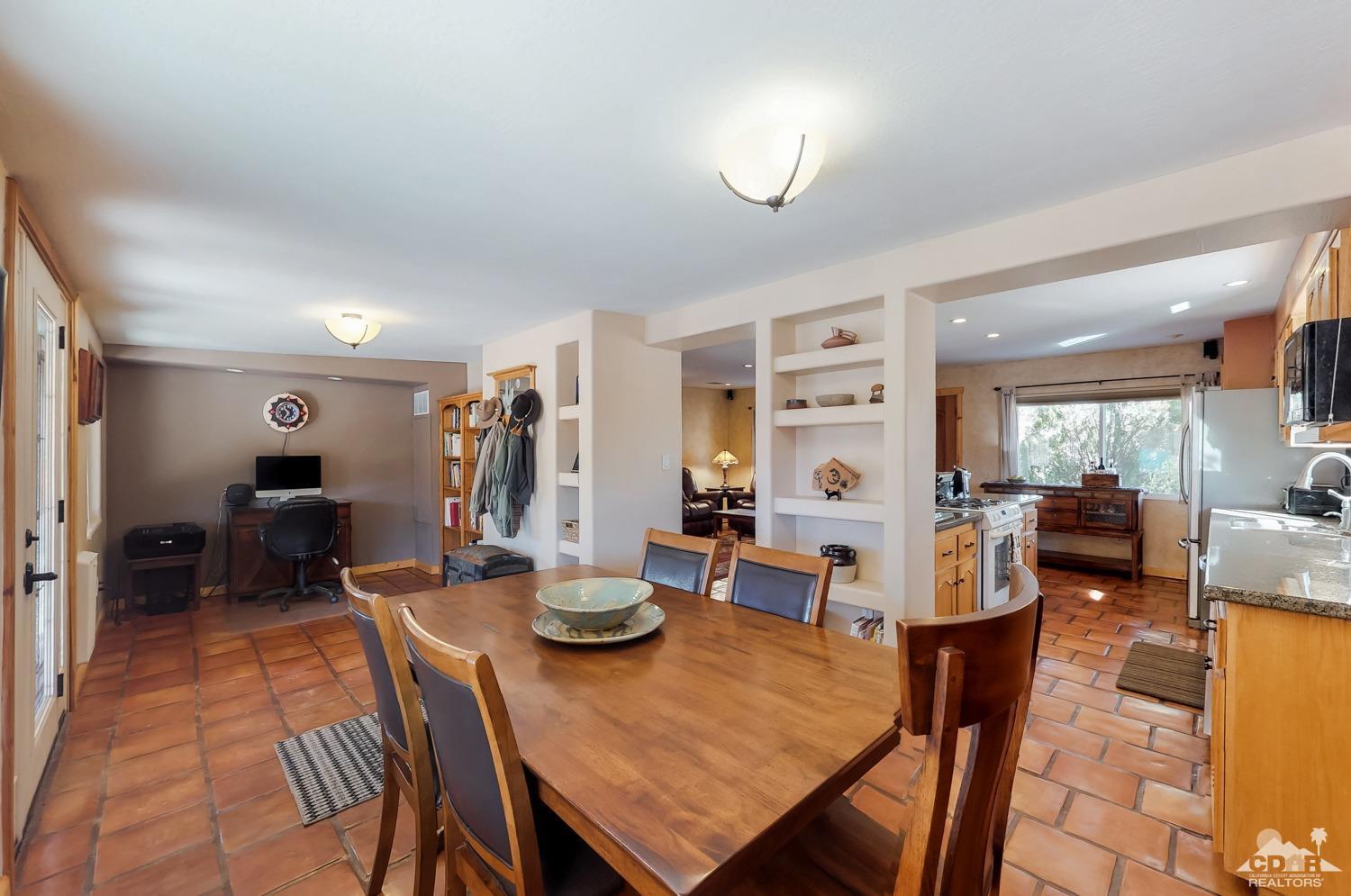 63443 Quail Springs Road Joshua Tree, CA 92252 - Photo 10 of 17 a view of a dining room with furniture and chandelier
