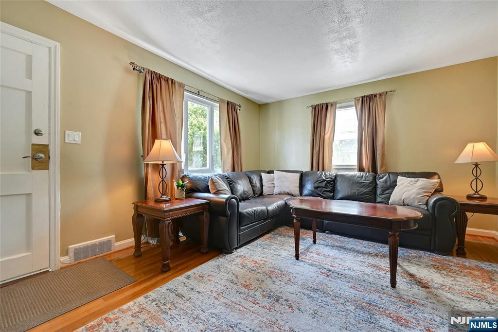 85 Edison Street Clifton, NJ 07013 - Photo 5 of 28 a living room with furniture and a wooden floor