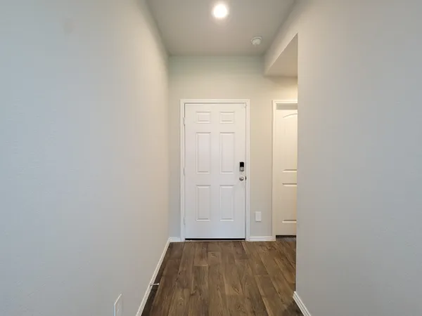 a view of an empty room and wooden floor