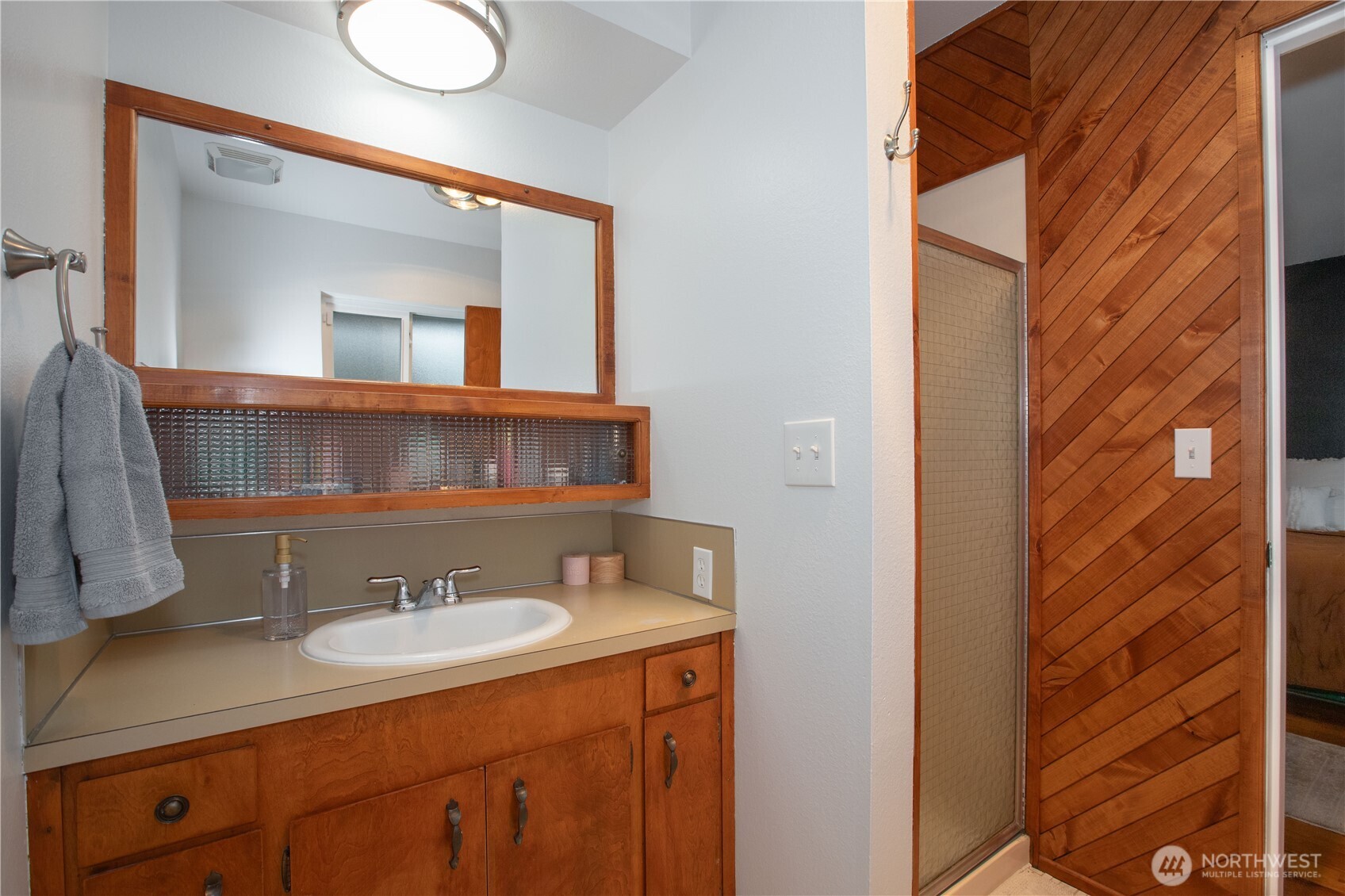 311 Ranger Drive Southeast Lacey, WA 98503 - Photo 18 of 35 a bathroom with a sink and a mirror