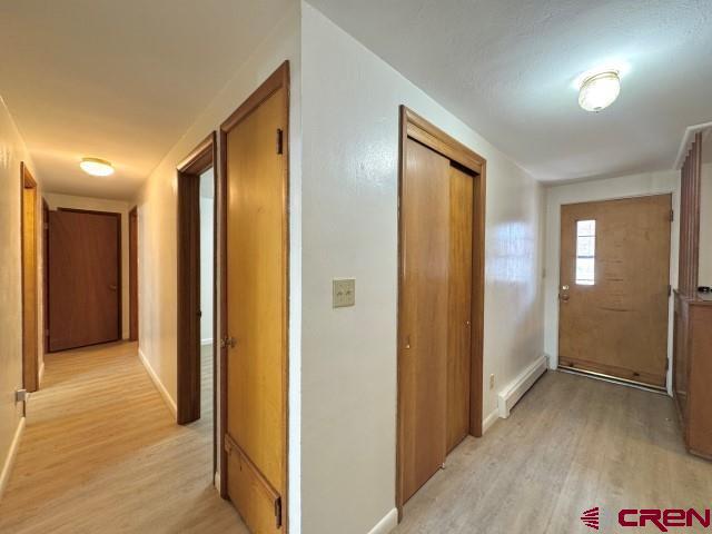 1221 First Street Alamosa, CO 81101 - Photo 11 of 40 a view of hallway with livingroom and wooden floor