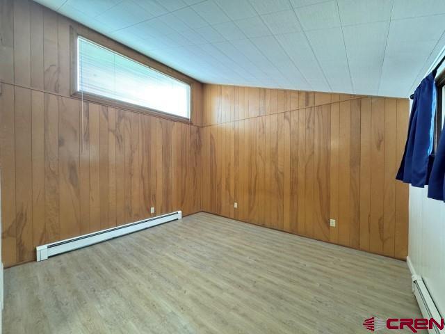 1221 First Street Alamosa, CO 81101 - Photo 14 of 40 a view of an empty room with wooden floor