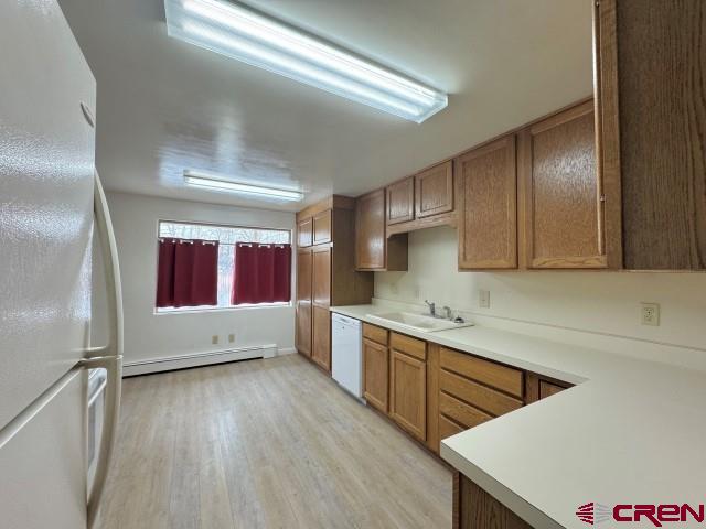 1221 First Street Alamosa, CO 81101 - Photo 18 of 40 a kitchen with stainless steel appliances a sink cabinets and wooden floor