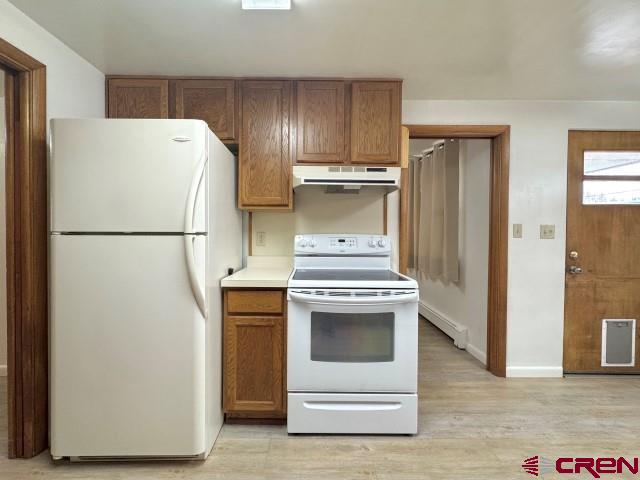 1221 First Street Alamosa, CO 81101 - Photo 19 of 40 a white refrigerator freezer and a stove sitting inside of a kitchen