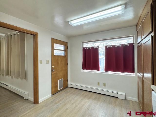 1221 First Street Alamosa, CO 81101 - Photo 22 of 40 a view of an empty room with wooden floor and a window