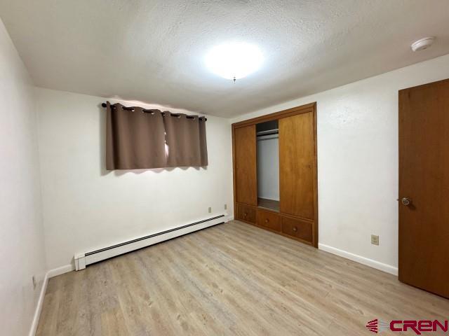1221 First Street Alamosa, CO 81101 - Photo 23 of 40 an empty room with wooden floor and windows