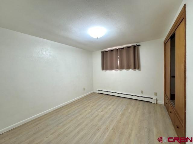 1221 First Street Alamosa, CO 81101 - Photo 24 of 40 an empty room with wooden floor and windows