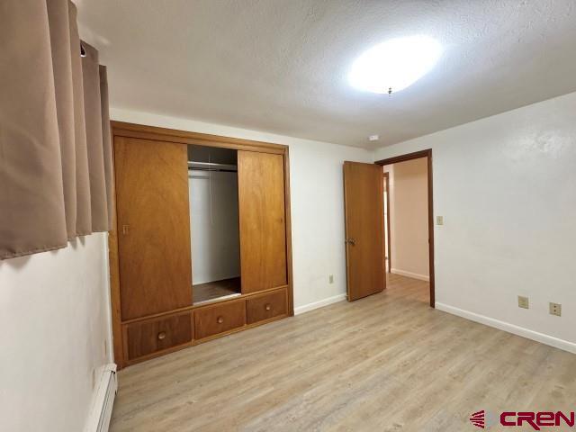 1221 First Street Alamosa, CO 81101 - Photo 25 of 40 an empty room with wooden floor and entrance