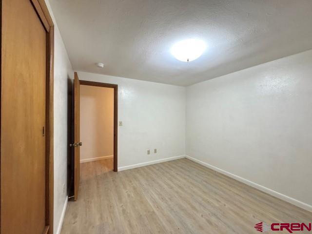 1221 First Street Alamosa, CO 81101 - Photo 26 of 40 an empty room with wooden floor and windows