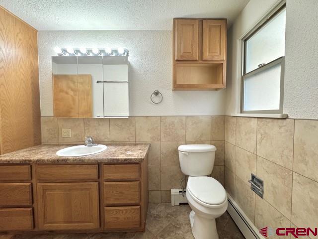 1221 First Street Alamosa, CO 81101 - Photo 29 of 40 a bathroom with a toilet sink and mirror