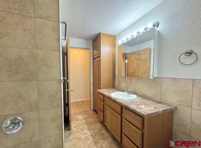 1221 First Street Alamosa, CO 81101 - Photo 30 of 40 a bathroom with a granite countertop sink and a mirror
