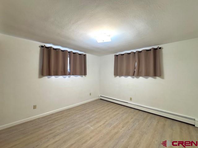1221 First Street Alamosa, CO 81101 - Photo 31 of 40 a view of an empty room with wooden floor