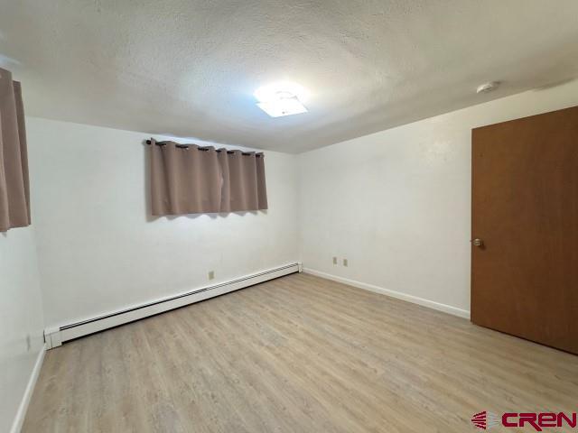 1221 First Street Alamosa, CO 81101 - Photo 32 of 40 an empty room with wooden floor and windows