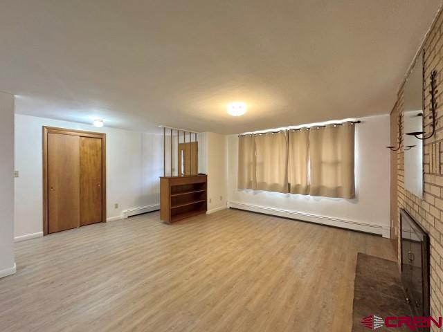 1221 First Street Alamosa, CO 81101 - Photo 6 of 40 a view of an empty room with a fireplace