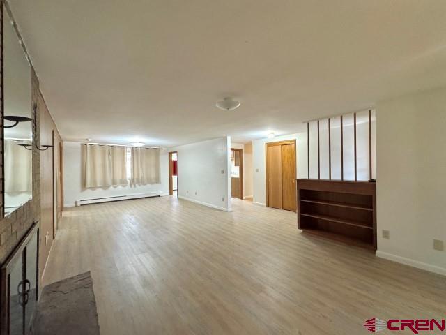 1221 First Street Alamosa, CO 81101 - Photo 10 of 40 wooden floor in an empty room with a window